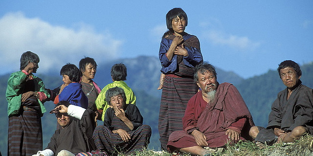 Bhutanese people with mountains. Photo by World Bank/Curt Carnemark